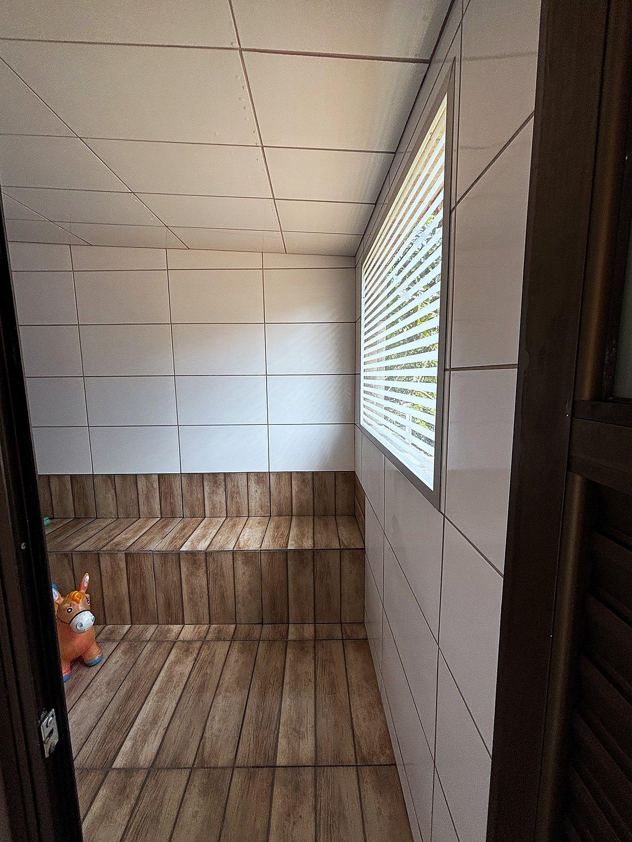 Sauna interna com bancada de madeira e cobogó